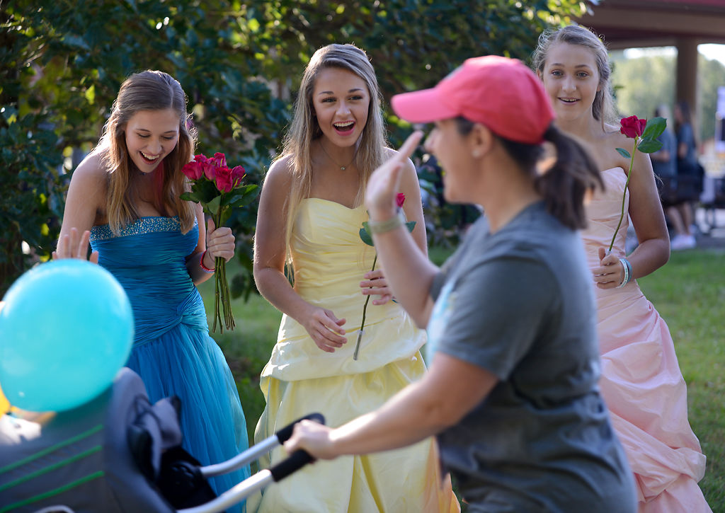 Logan Hovis, Anna Byergo and Ella Byergo greet participants